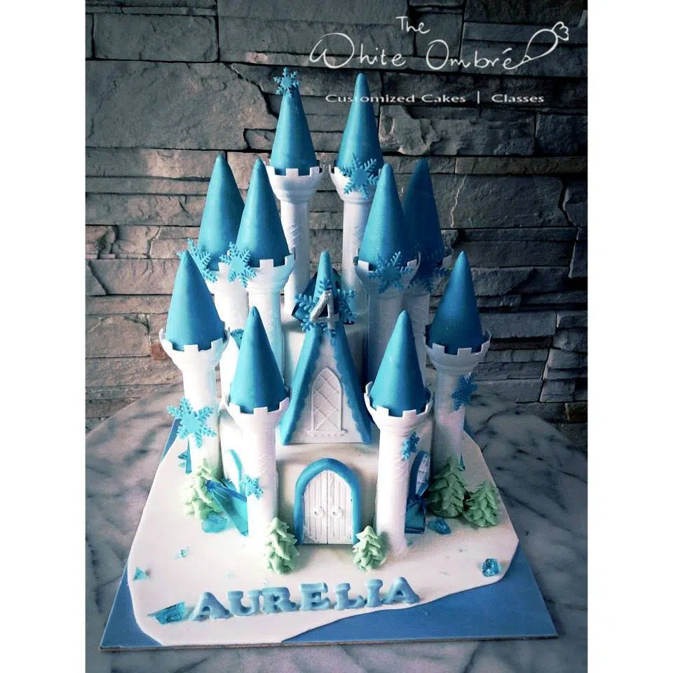 A multi-tiered cake with decoration made of fondant that resemble the ice castle from Frozen. Pulse Patisserie. Source