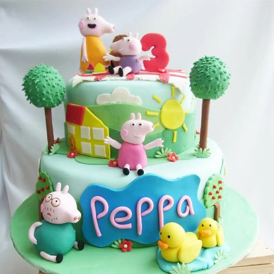 A two-tiered fondant cake with edible figurines of Peppa, George, Mummy and Daddy Pig, and fondant cutouts to fully decorate the cake.  Corine and Cake.Source