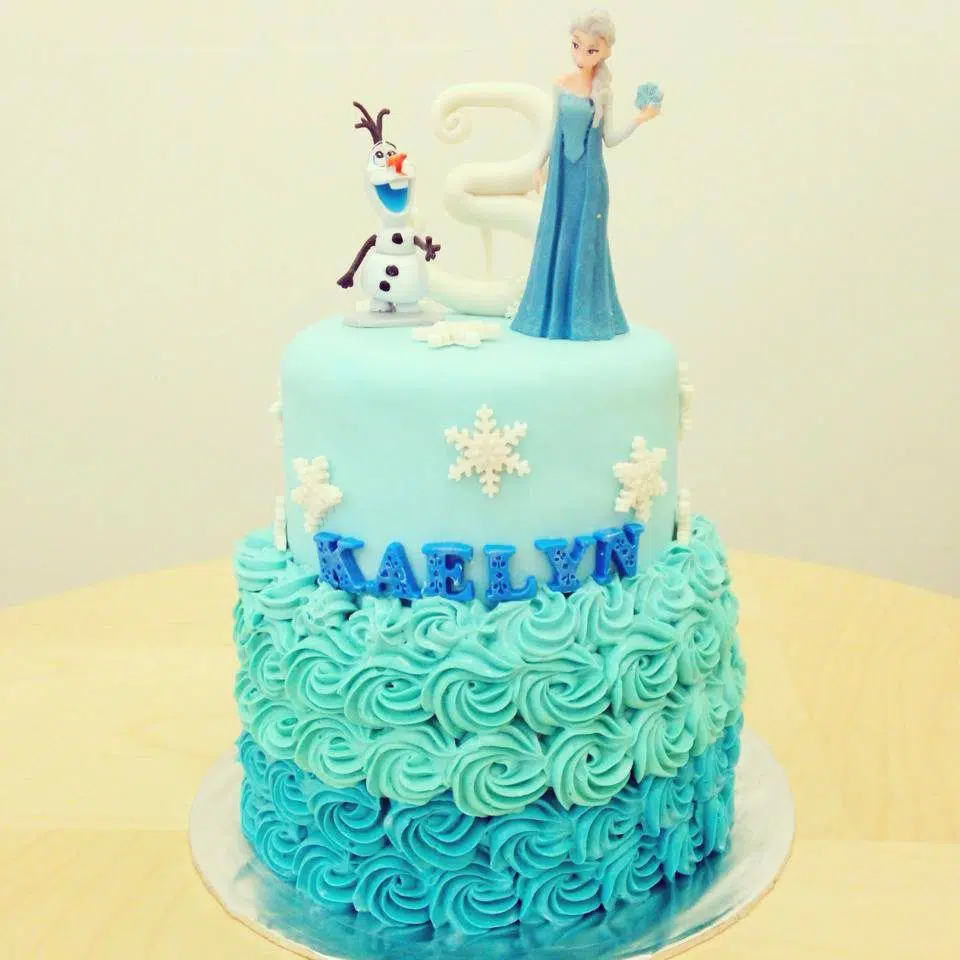A two-tiered Frozen themed cake decorated with buttercream and fondant. Little House of Dreams. Source