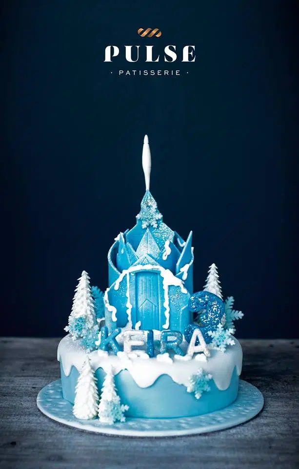 Queen Elsa’s Ice Castle cake made of blue and white fondant. Made by: Pulse Patisserie. Source