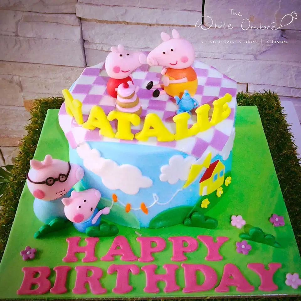 A round cake with fondant decorations and edible figurines of Peppa, George, Mummy and Daddy Pig. The White Ombre.Source