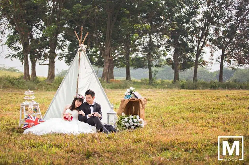 Outdoor picnic pre-wedding photoshoot on a grassy field in Kuala Lumpur by Moco Photography, wedding photographer on Recommend.my