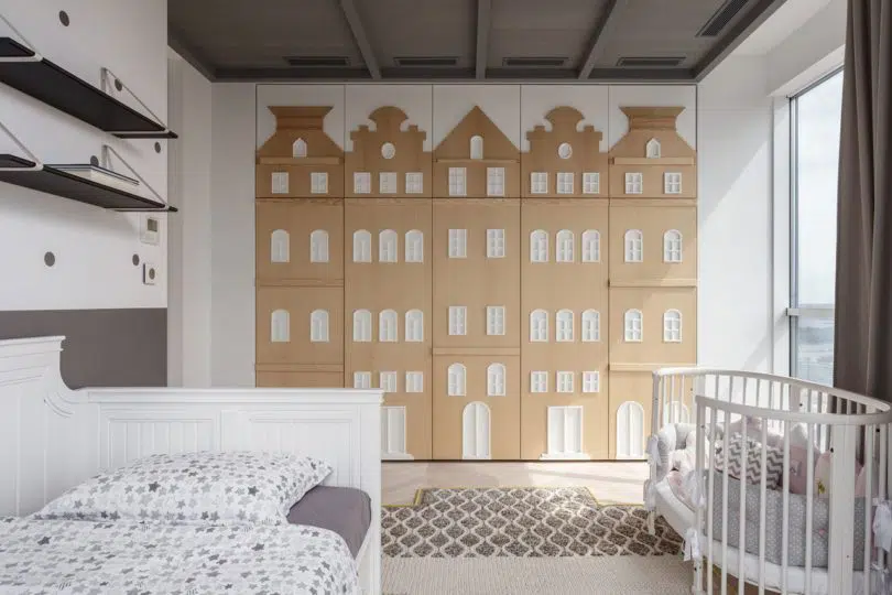 Baby bedroom with wood cutouts on wardrobe door