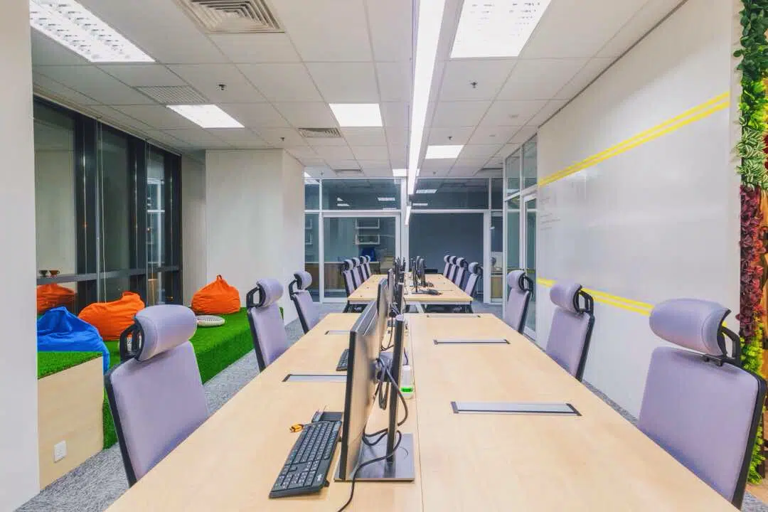 Office interior design with glass partitions and large outer windows for maximum natural light at ByondWave office. Source: EzyOffice