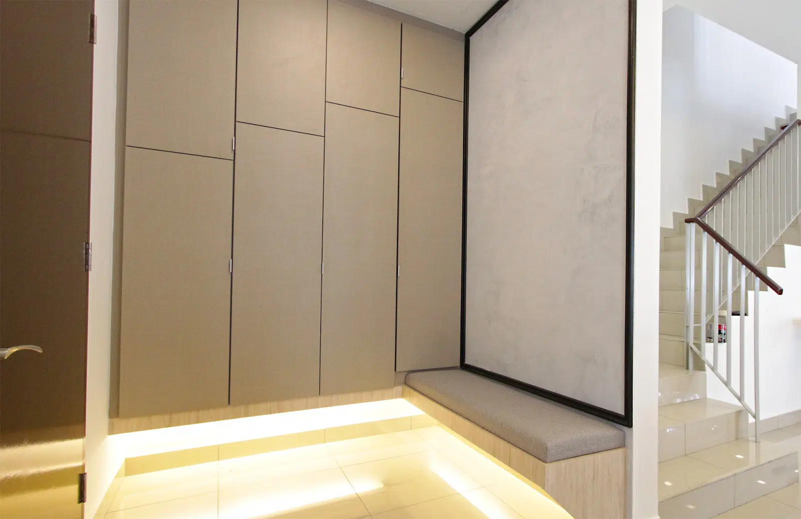 Top: Built-in wardrobe in one of the bedrooms. Above: Built-in cabinets and a seating area near the foyer area.