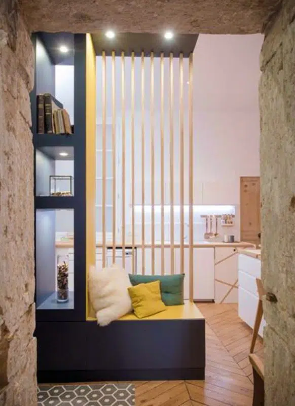 Bright yellow partition with wooden slats and seating