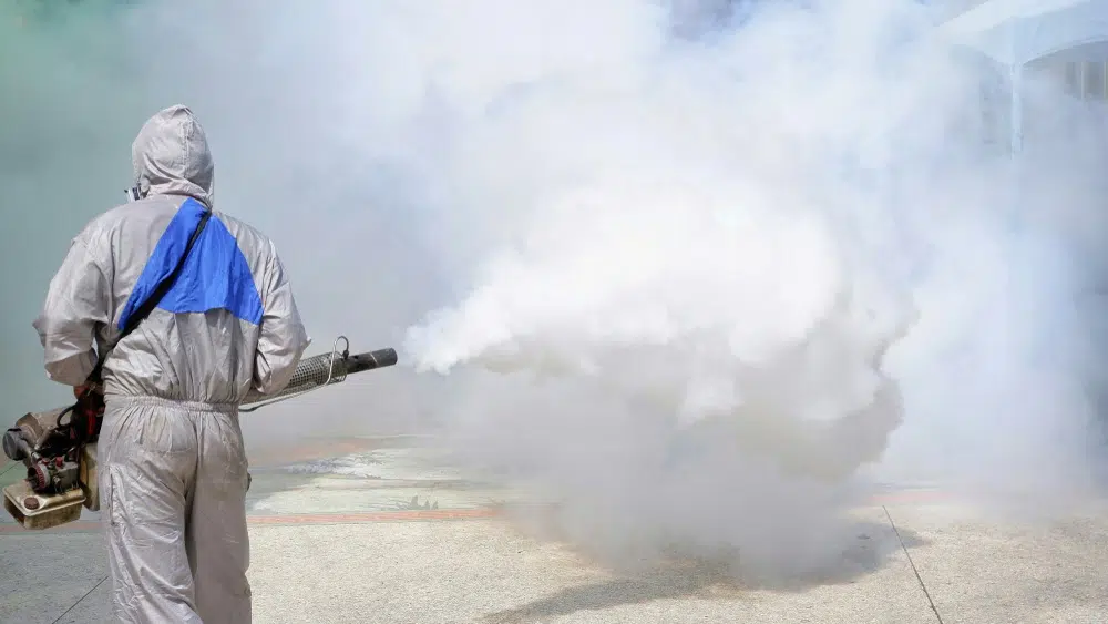 A professional disinfecting team applying the fogging/misting method on a premise