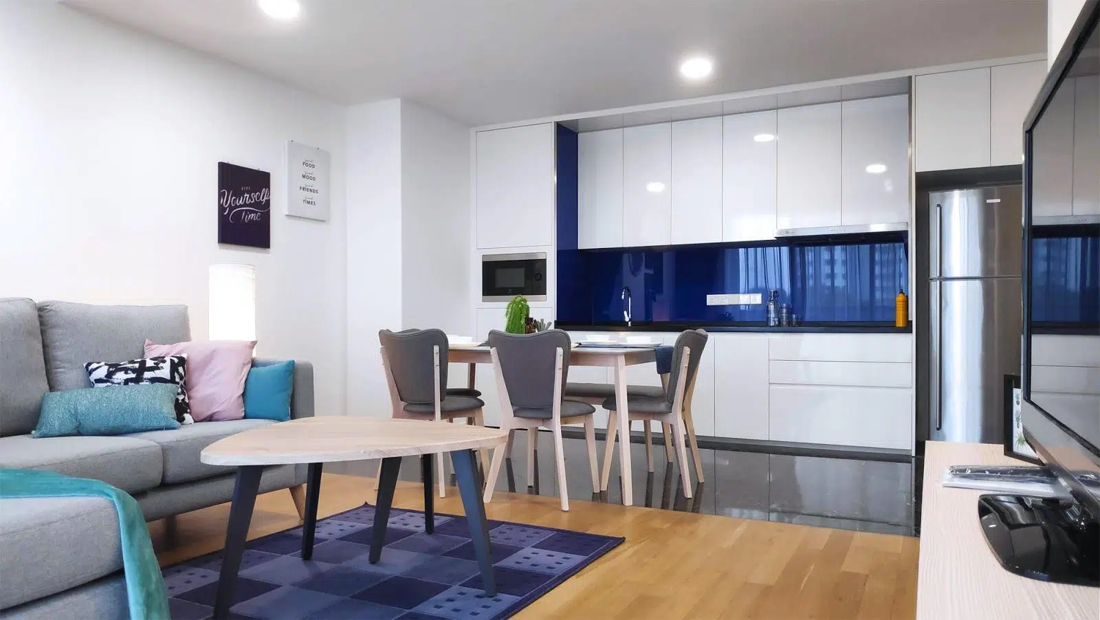 Pantry area with melamine built-in cabinets and grey dining table set