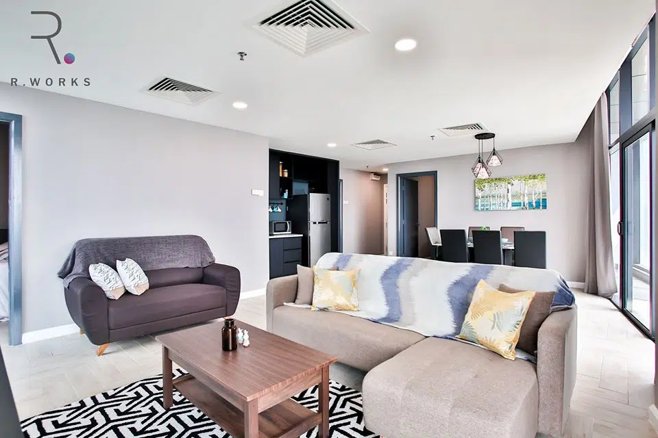 Minimally furnished living room in brown shades with subtle colourful accents 