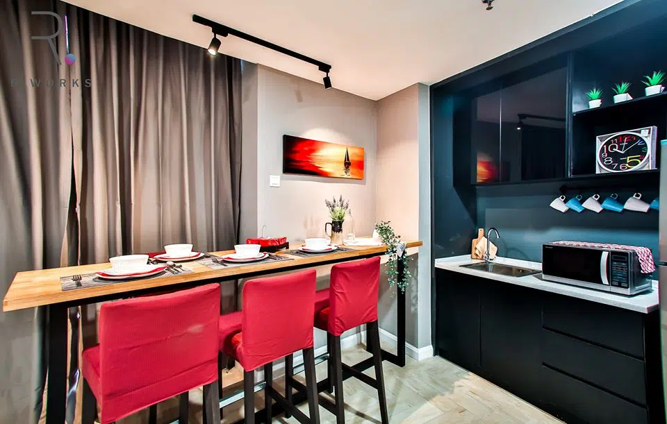 Kitchenette and dining area in bright red at the Empire City unit, Damansara 