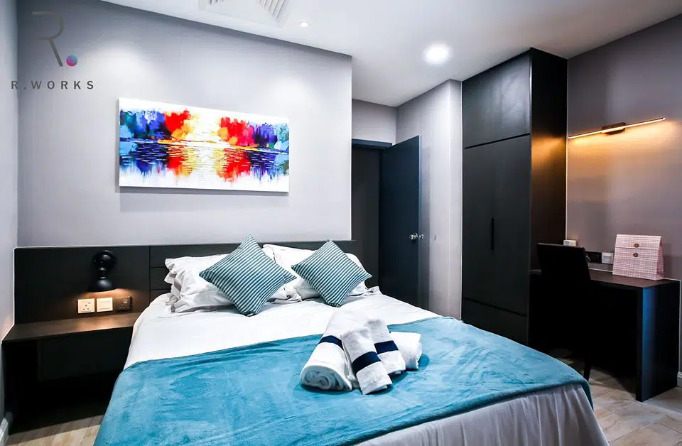 Striking blue and red accents in the first bedroom at Empire City, Damansara