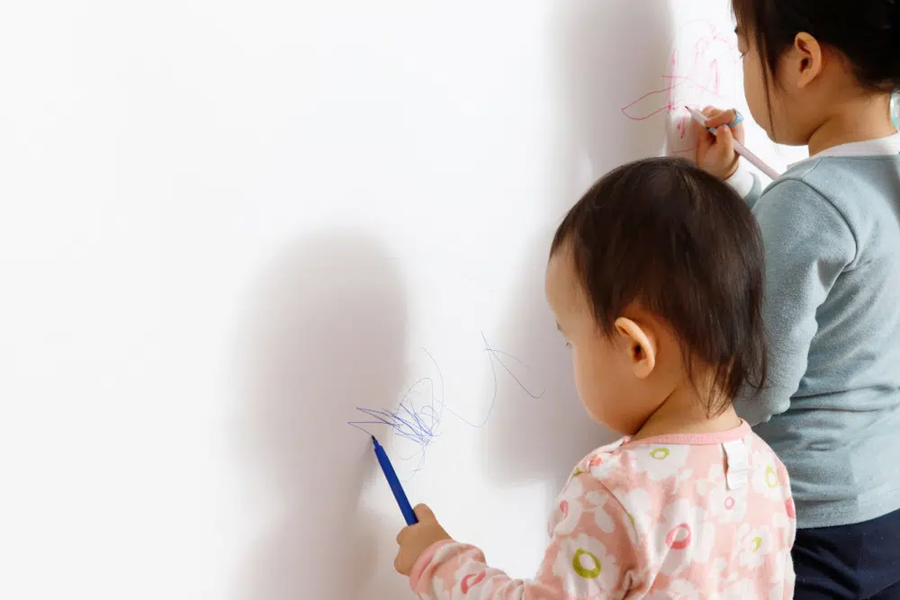 Children scribbling on walls 