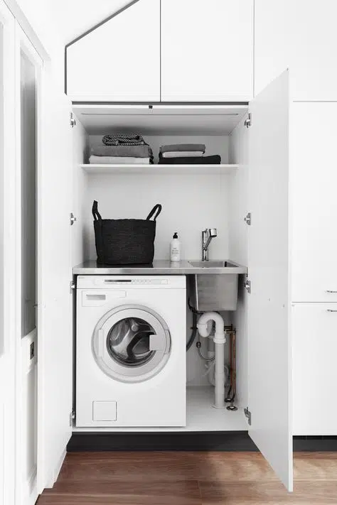 Hidden laundry nook with modern industrial monochrome design